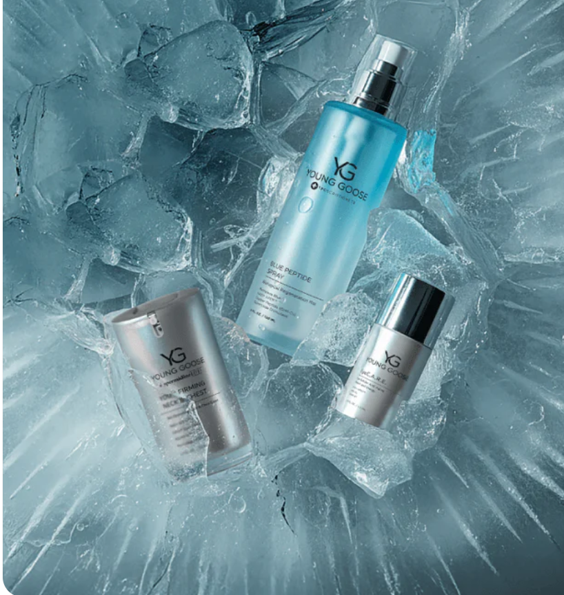 Young Goose skincare products displayed on cracked ice, featuring Blue Peptide Spray and anti-aging serums in a cool, frosty aesthetic.
